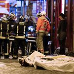 Rescue workers gather at victims in the 10th district of Paris, Friday, Nov. 13, 2015.